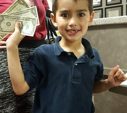 A child participating in Operation Gratitude Candy Buy Back at Lydiatt and Duru Family Dentistry.