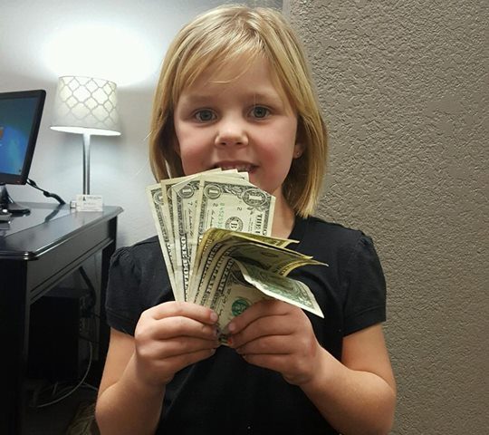 A child participating in Operation Gratitude Candy Buy Back at Lydiatt and Duru Family Dentistry.