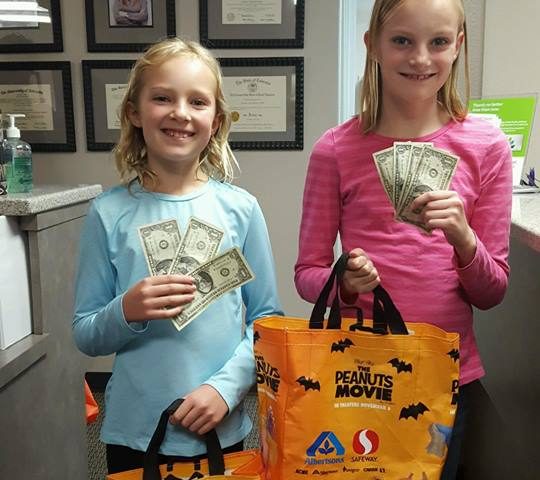 Two children participating in Operation Gratitude Candy Buy Back at Lydiatt and Duru Family Dentistry.